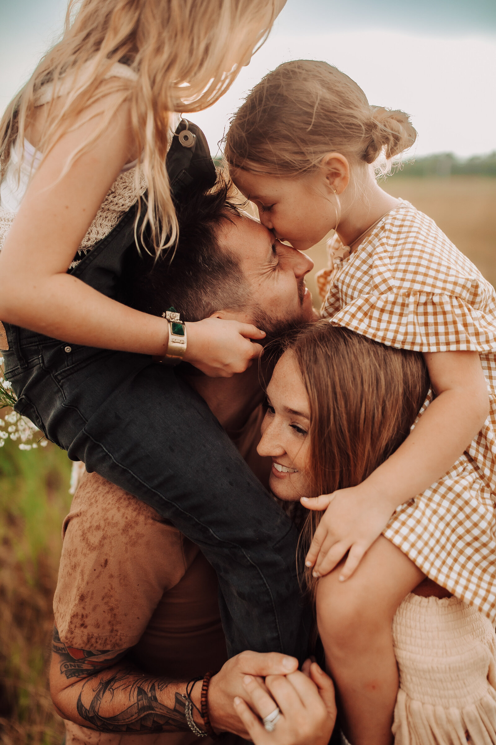 stacked-family-mom-dad-kiss-field