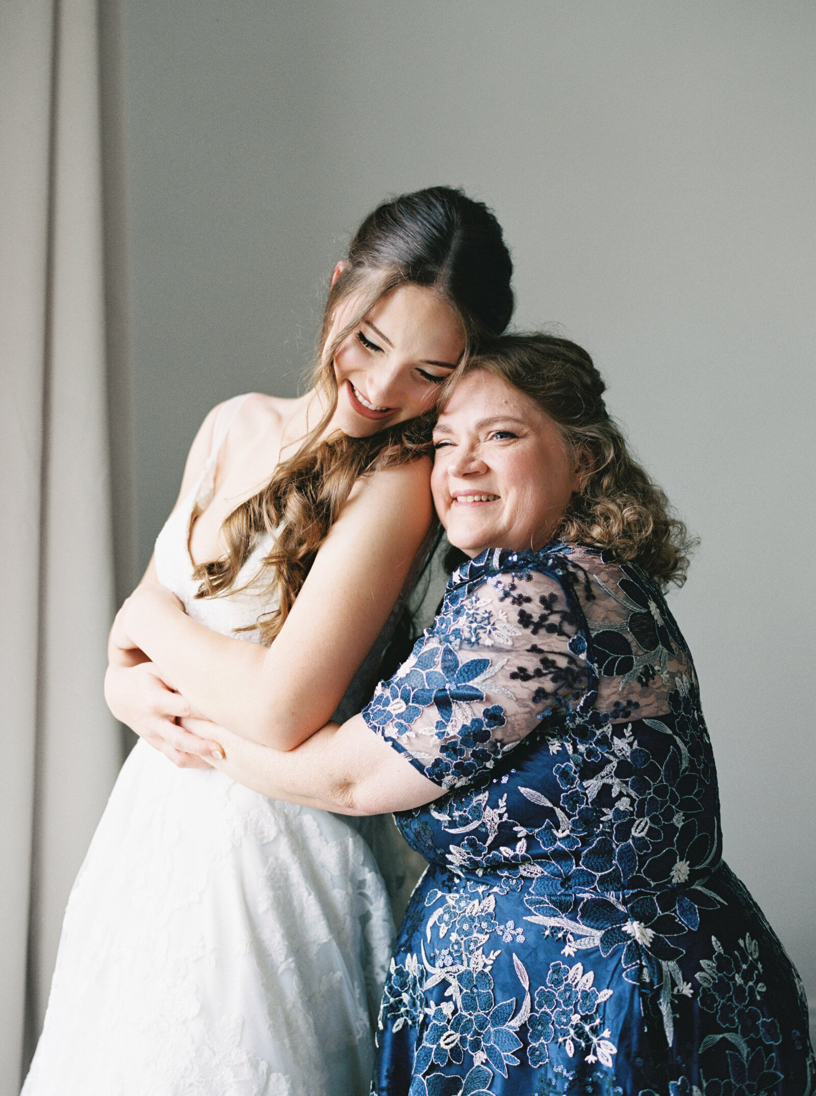 Emotional moment of mother and daughter hugging on the bride’s wedding day, captured on film by Morgan Alysse, Louisiana film photographer.