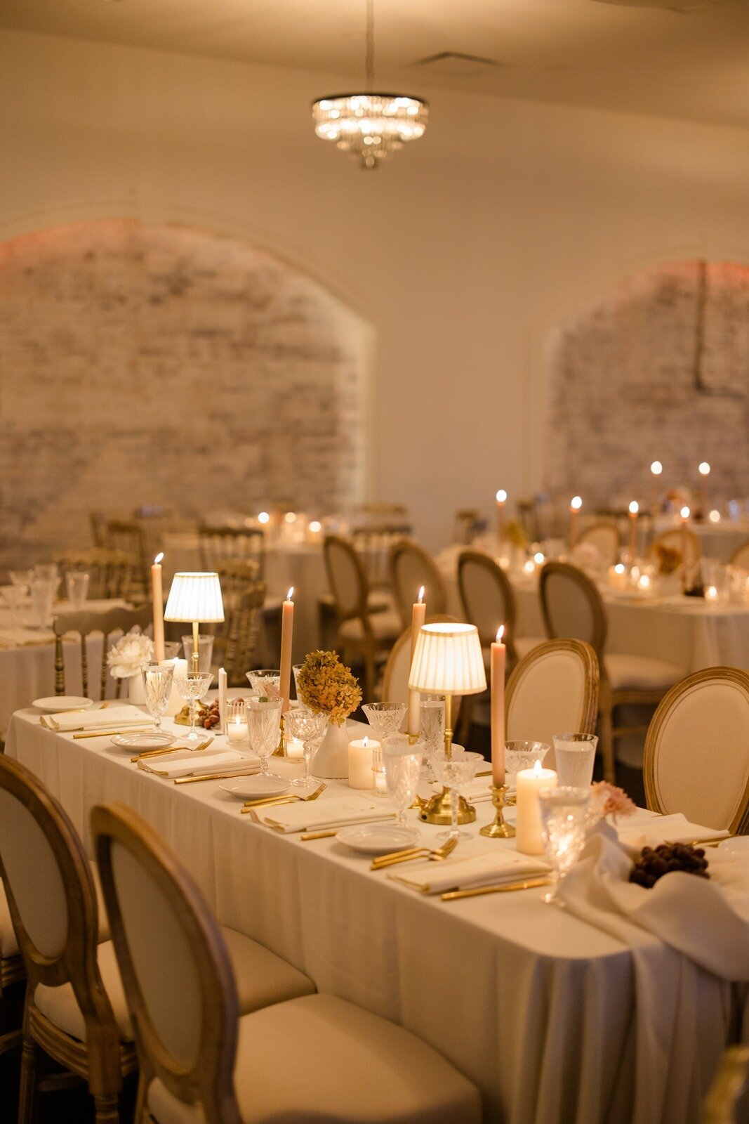 a candle light long table settings in the luxe room at grbic events in st louis