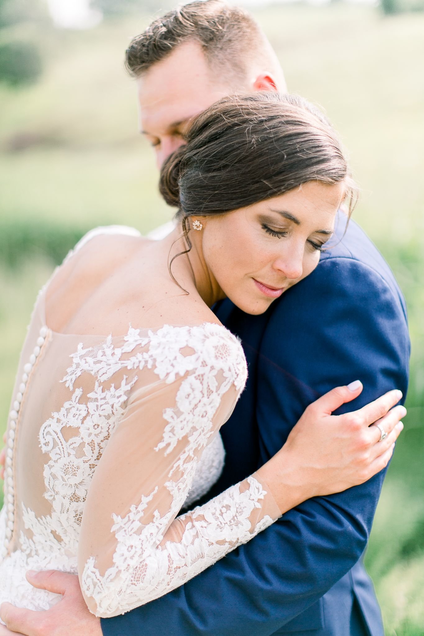 Airy wedding portrait of a bride and groom embracing at an outdoor wedding in Maine