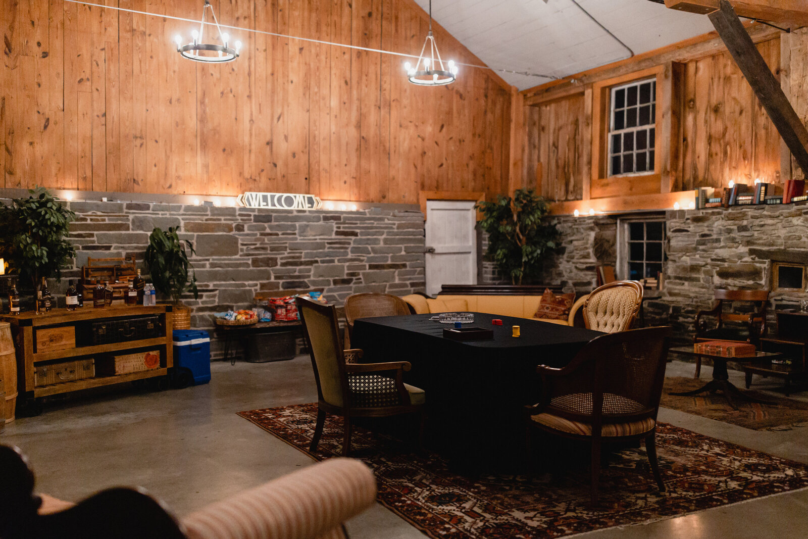 stone and wood barn with poker table and vintage furniture
