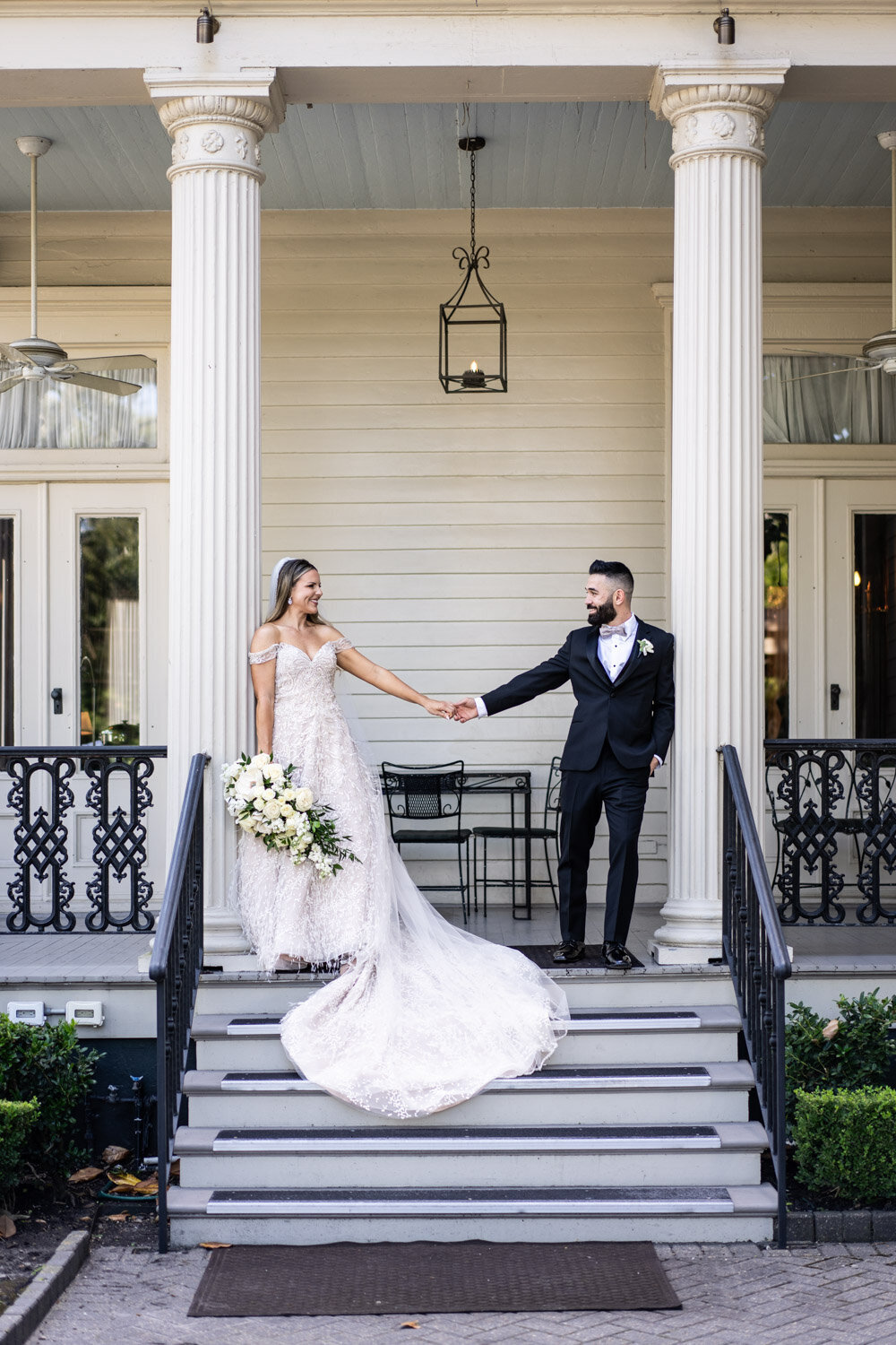 Couple on back porch of Elms Mansion wedding venue in New Orleans