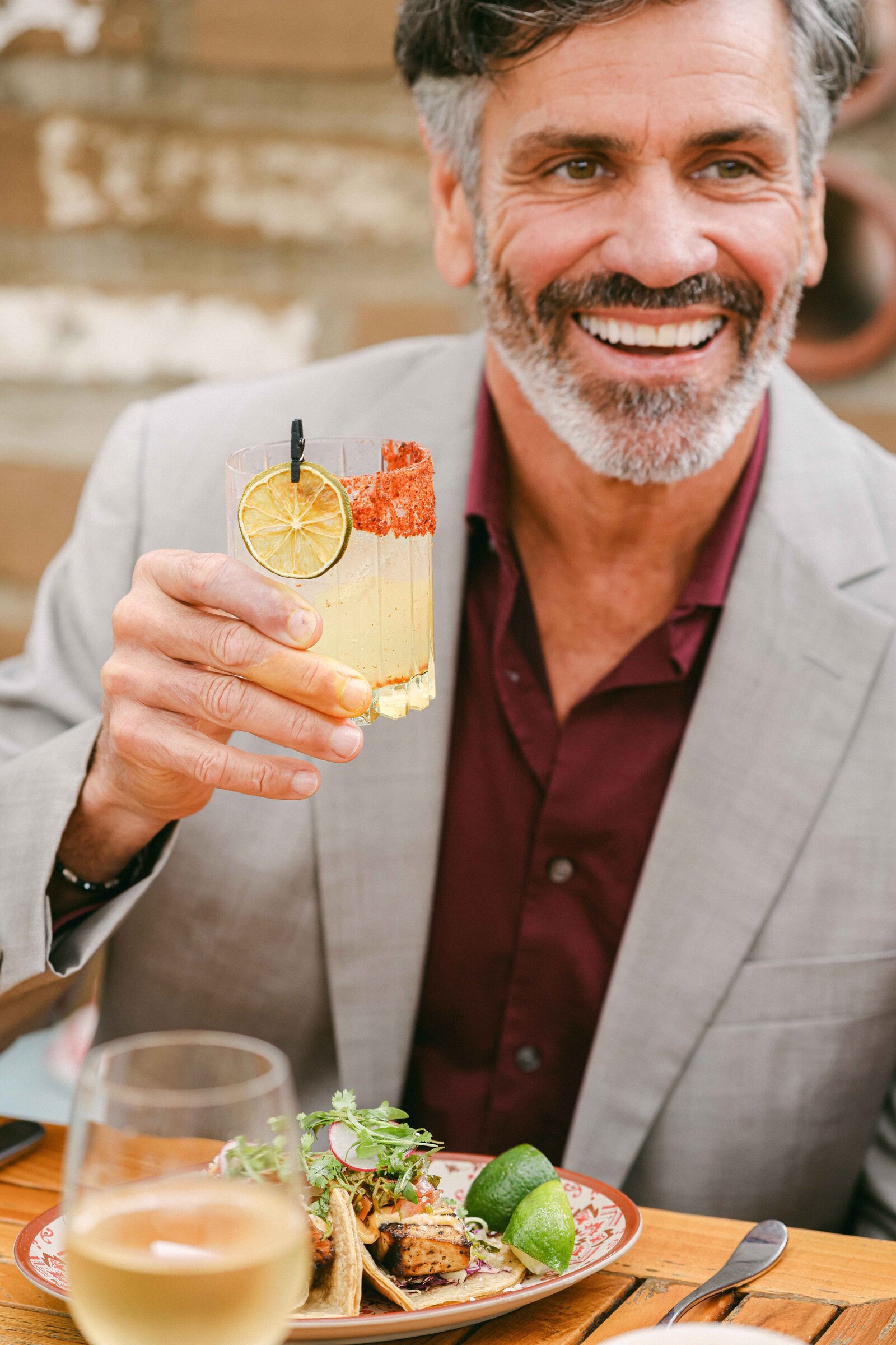 Corporate event photography lifestyle dinner cocktails handsome man cheersing his drink