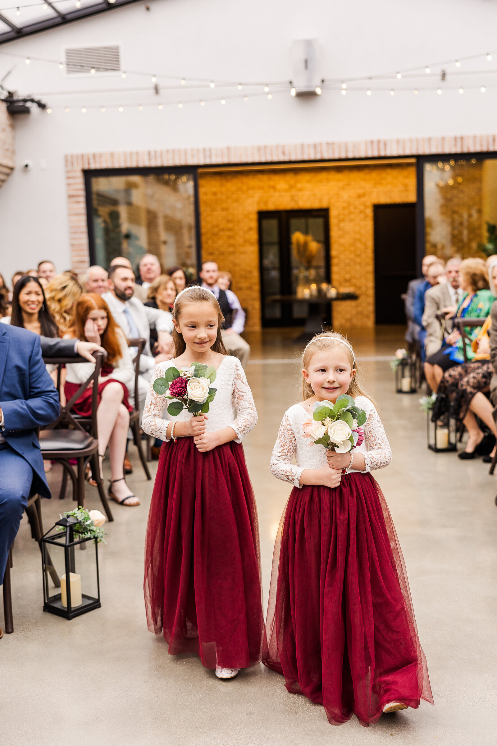 Adorable flower girls walking down the aisle at Perona Farms wedding ceremony in Andover, NJ