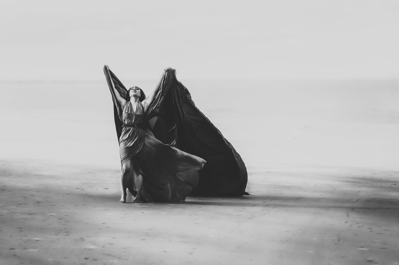 Savannah Georgia Boudoir and Glamour Woman in blue parachute gown on beach in black and white