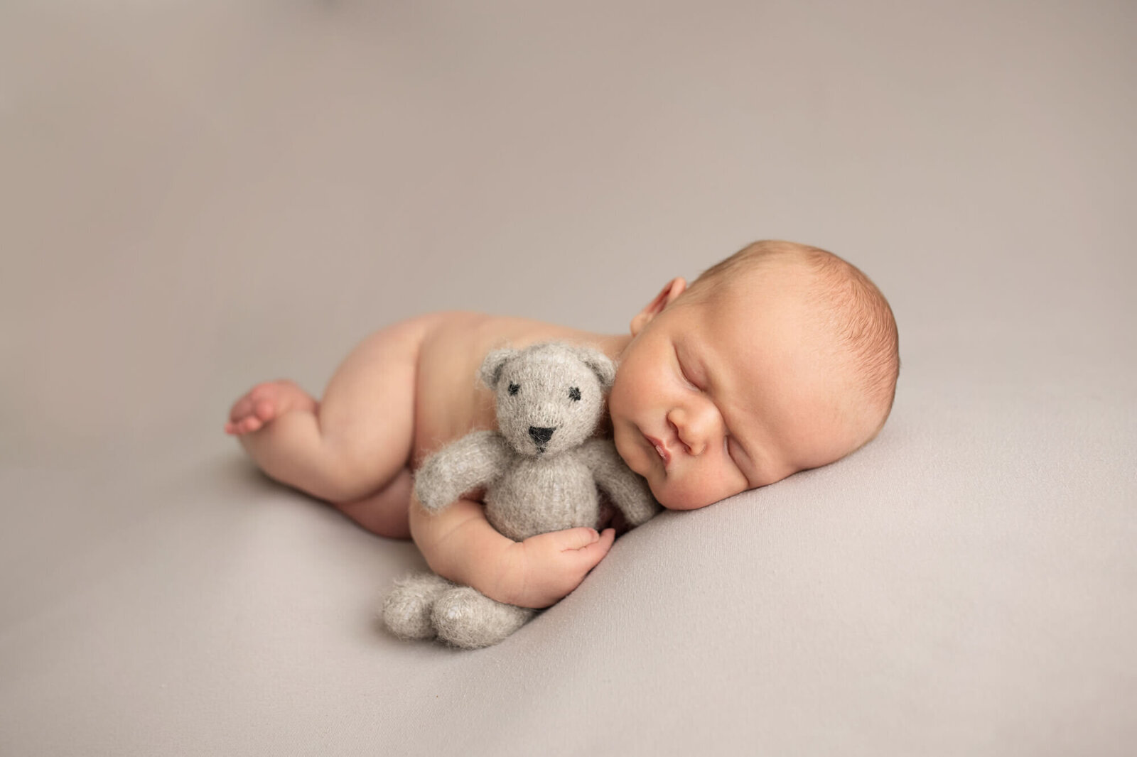 Newborn boy with teddy bear