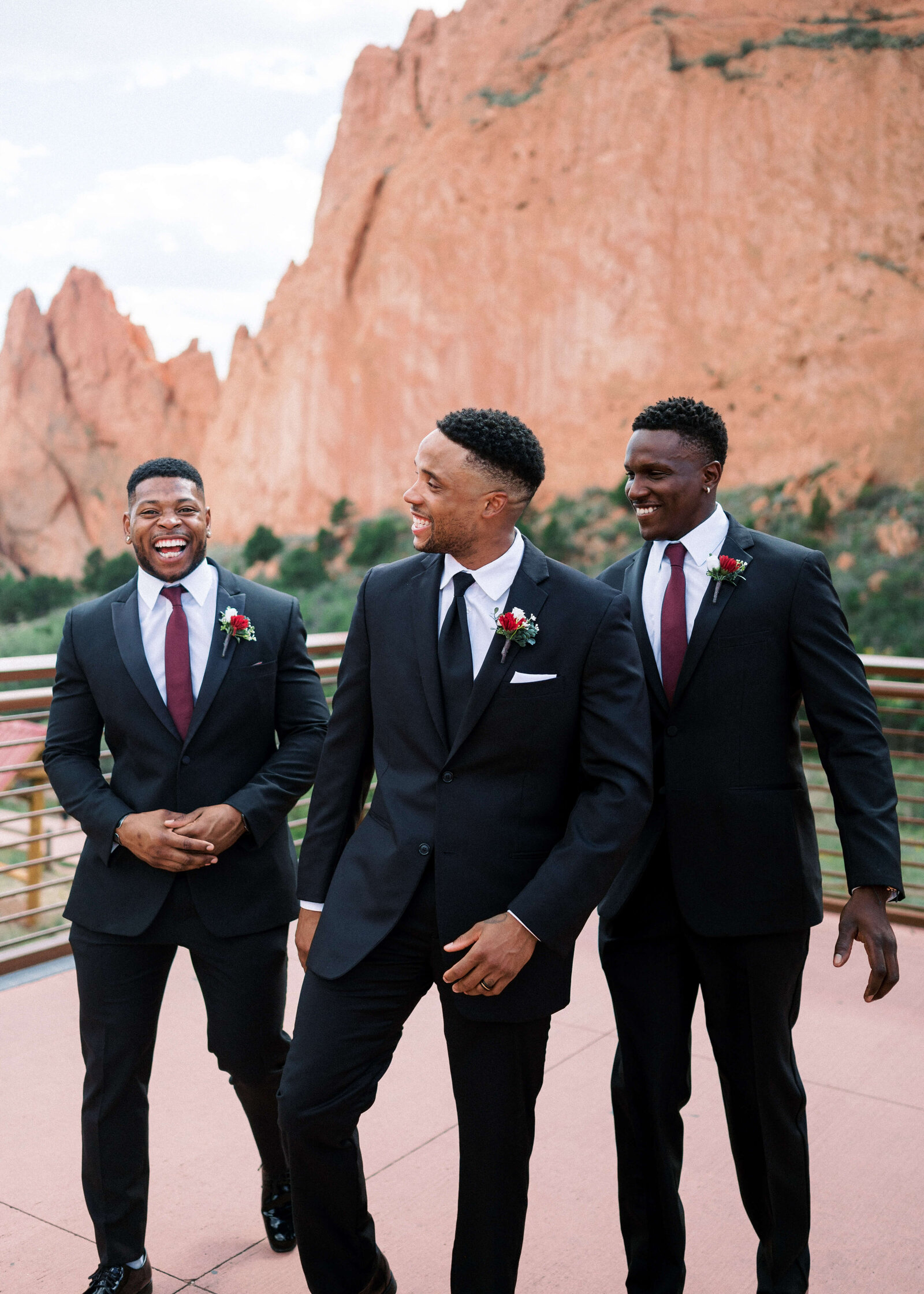 groom and his groomsmen laughing and walking together