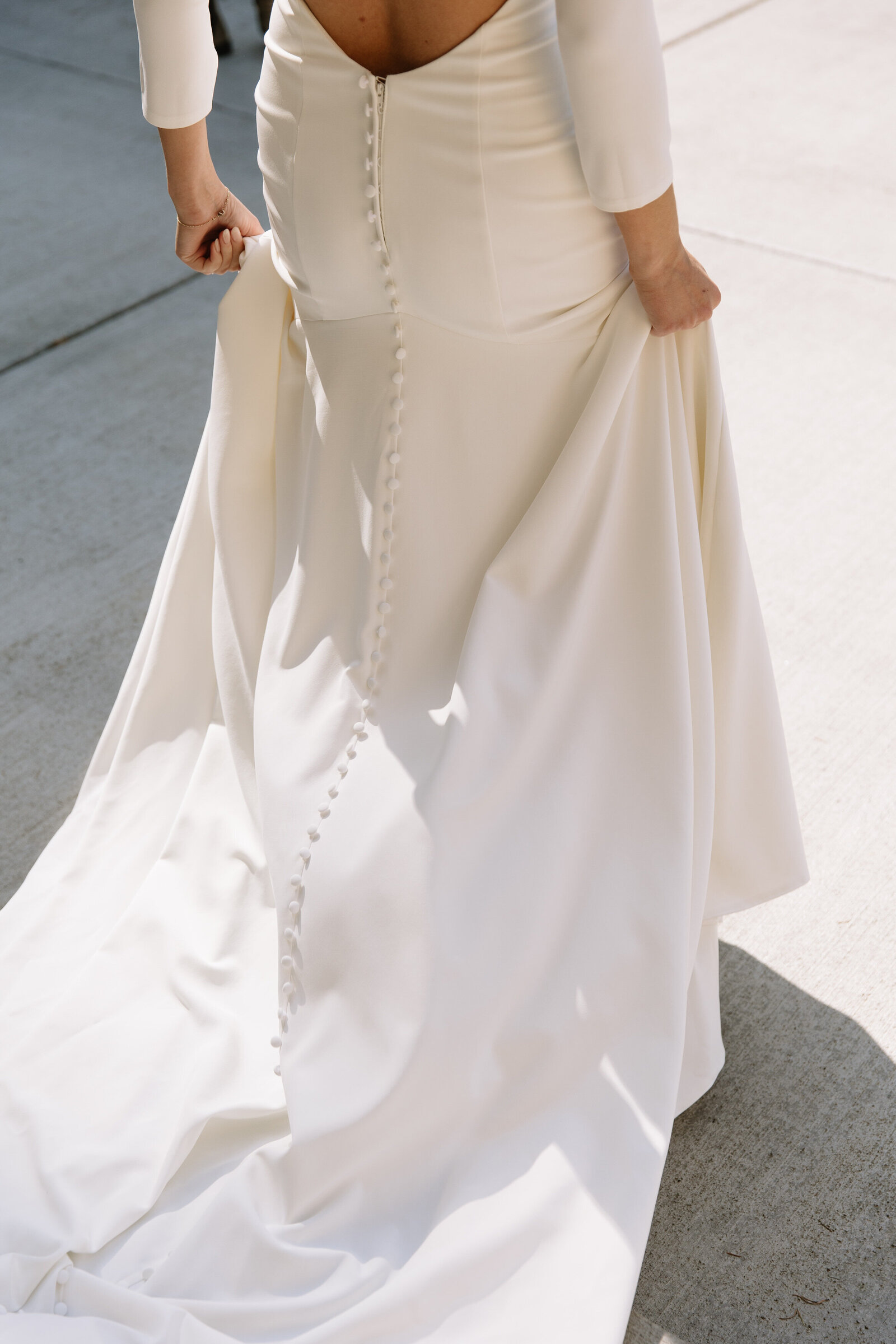 Bride walking in her dress while holding train before Washington elopement