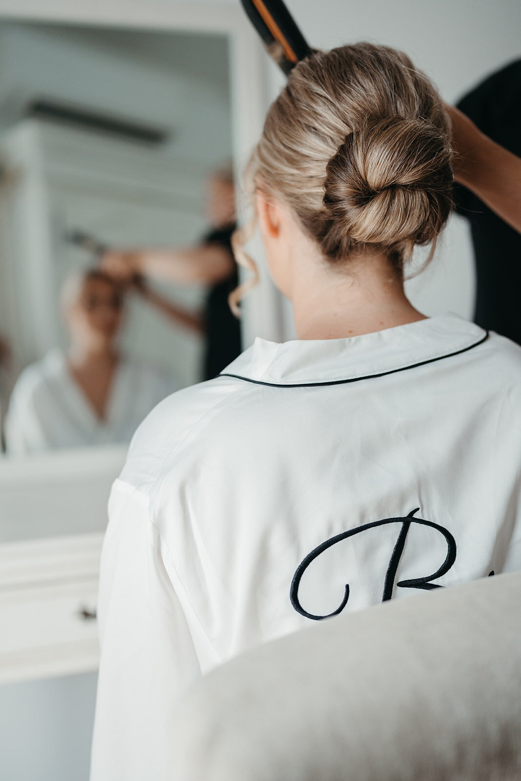 Beautiful Bella Rae Bride Kristen getting her face framing curled to finish off her low twisted bun at Austin Villa Estate captured by Daniel Chafer Photography