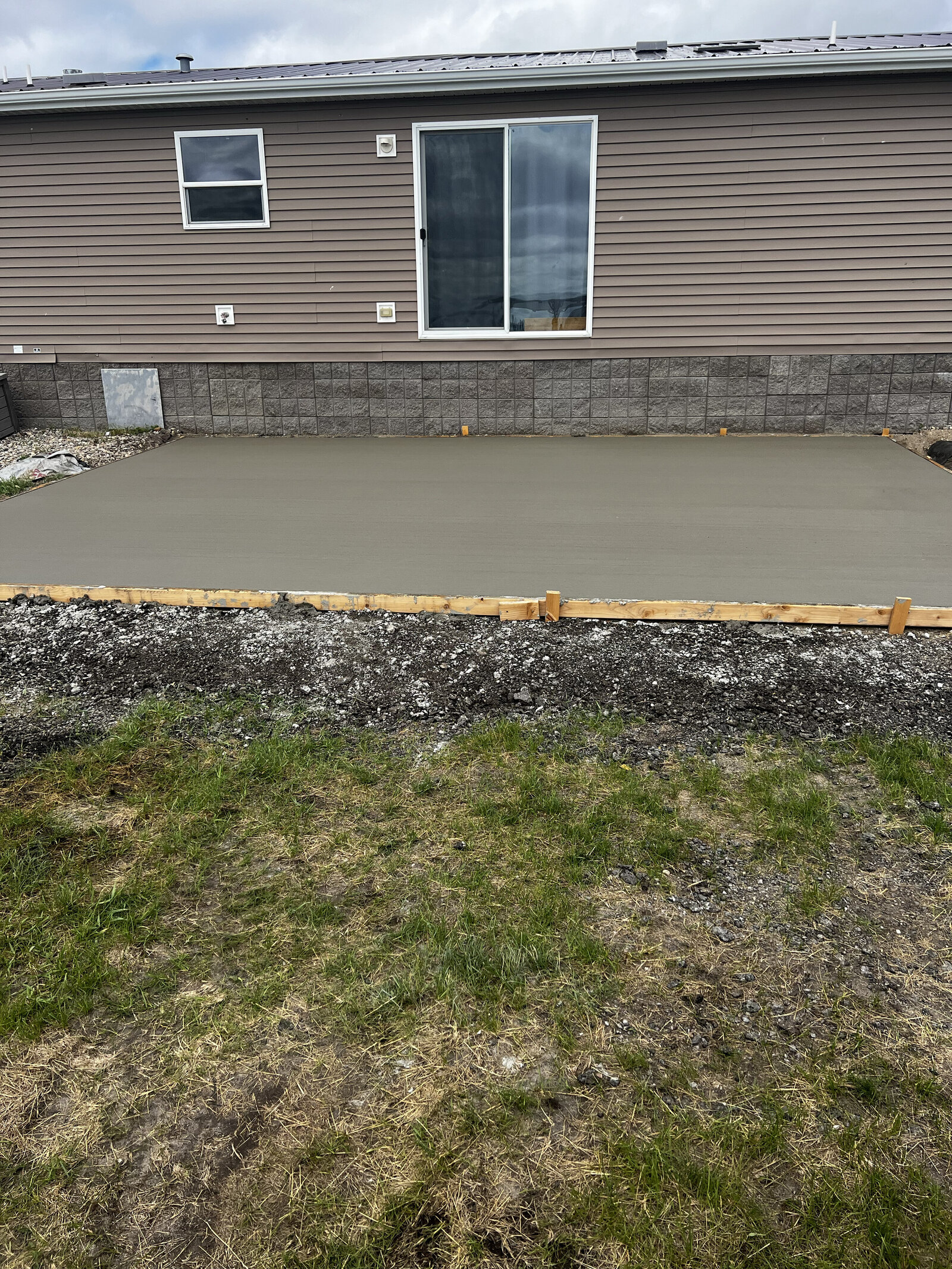 concrete patio in backyard of house