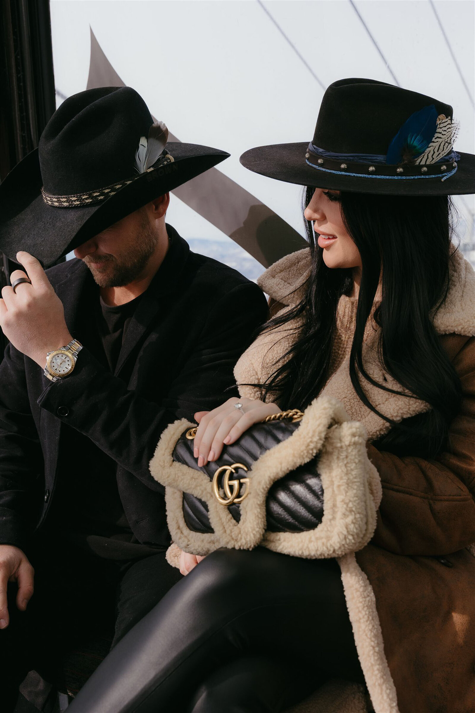 Couple riding gondola during Aspen winter engagement session