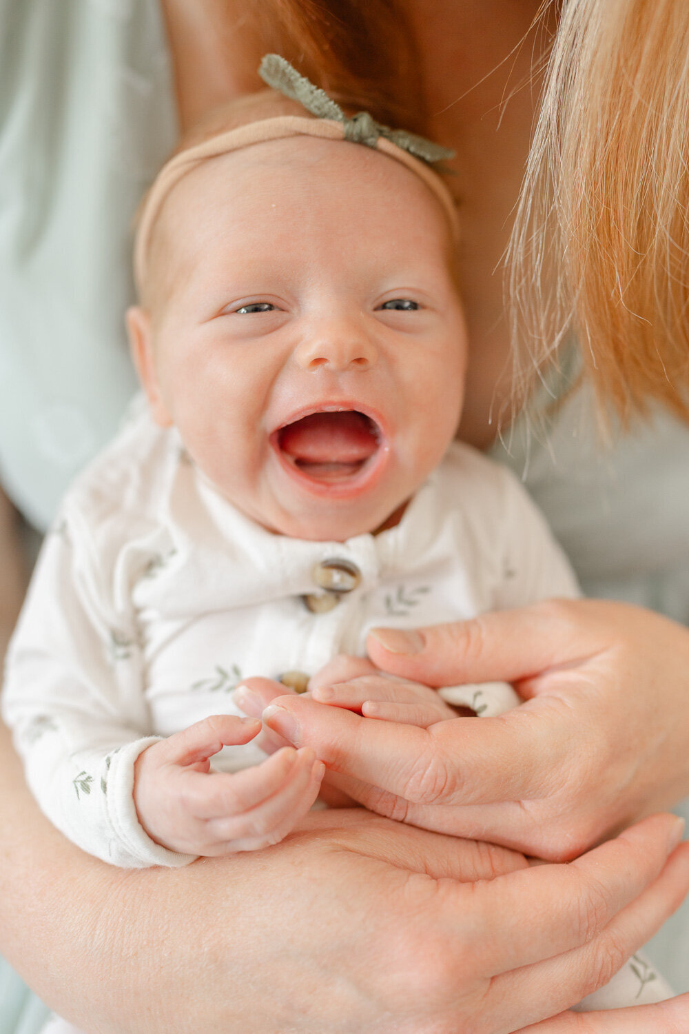 baby with big smile taken by TBP, a McLean, Virginia newborn photographer