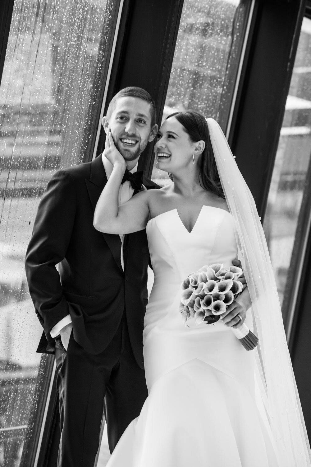 A black and white photo of a bride and groom