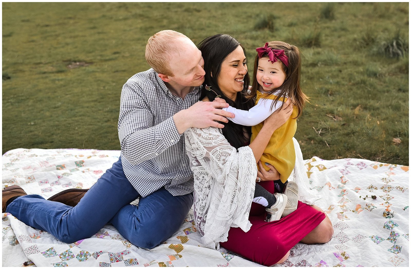 Family laying on blanket maternity photo session hugging little girl Emily Ann Photography Seattle Photographer.