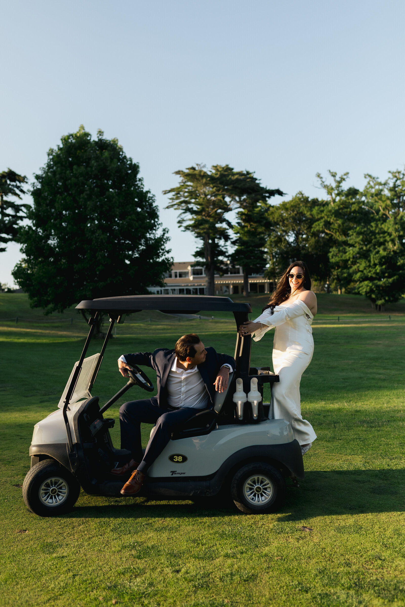 BrideAndGroomOnGolfCart