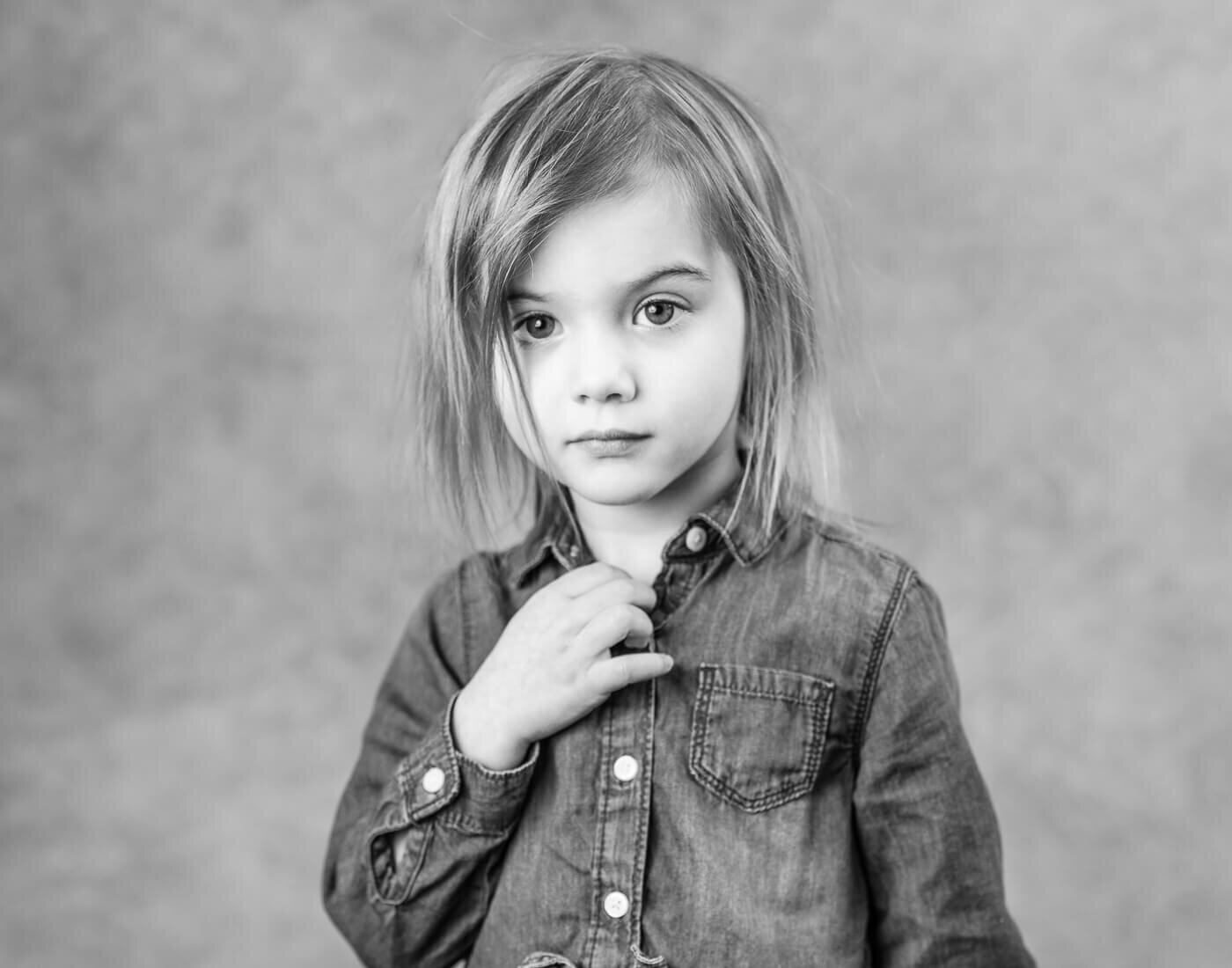 A child holds their button up shirt.