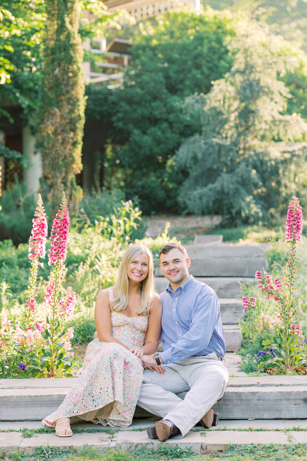 Couple holds hands in botanical garden engagement