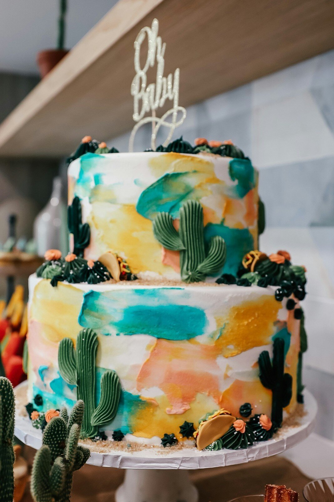 Colorful cactus-themed baby shower cake with watercolor design