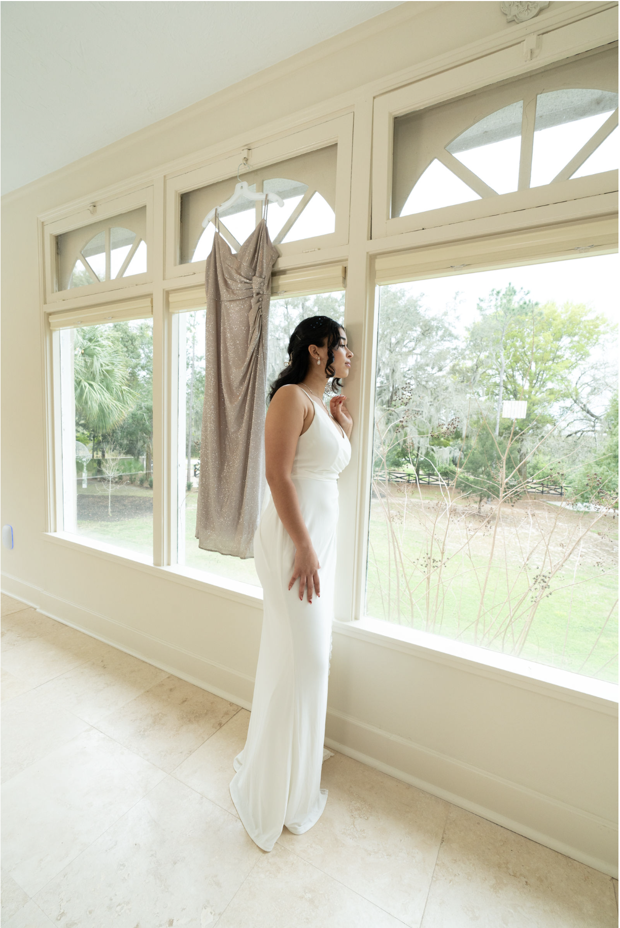 Bride looking out of bridal suite window