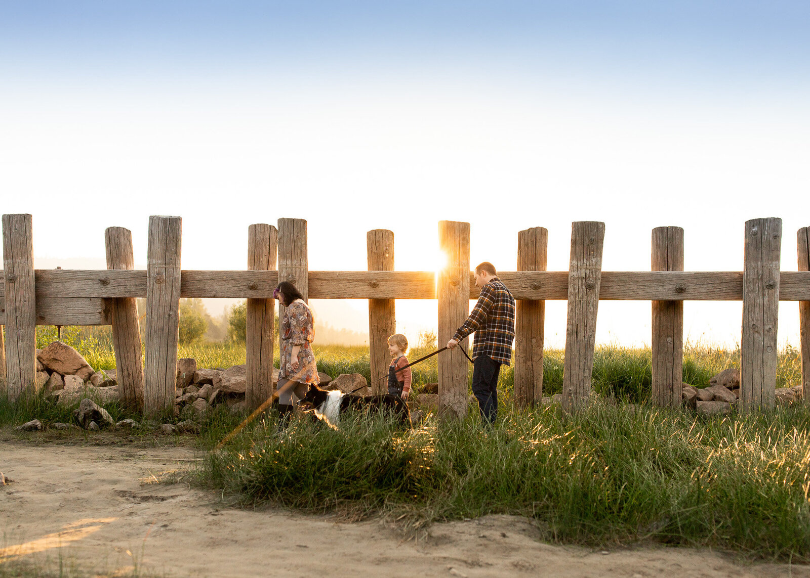 Family of three walking on beach at Rooster Rock State Park.