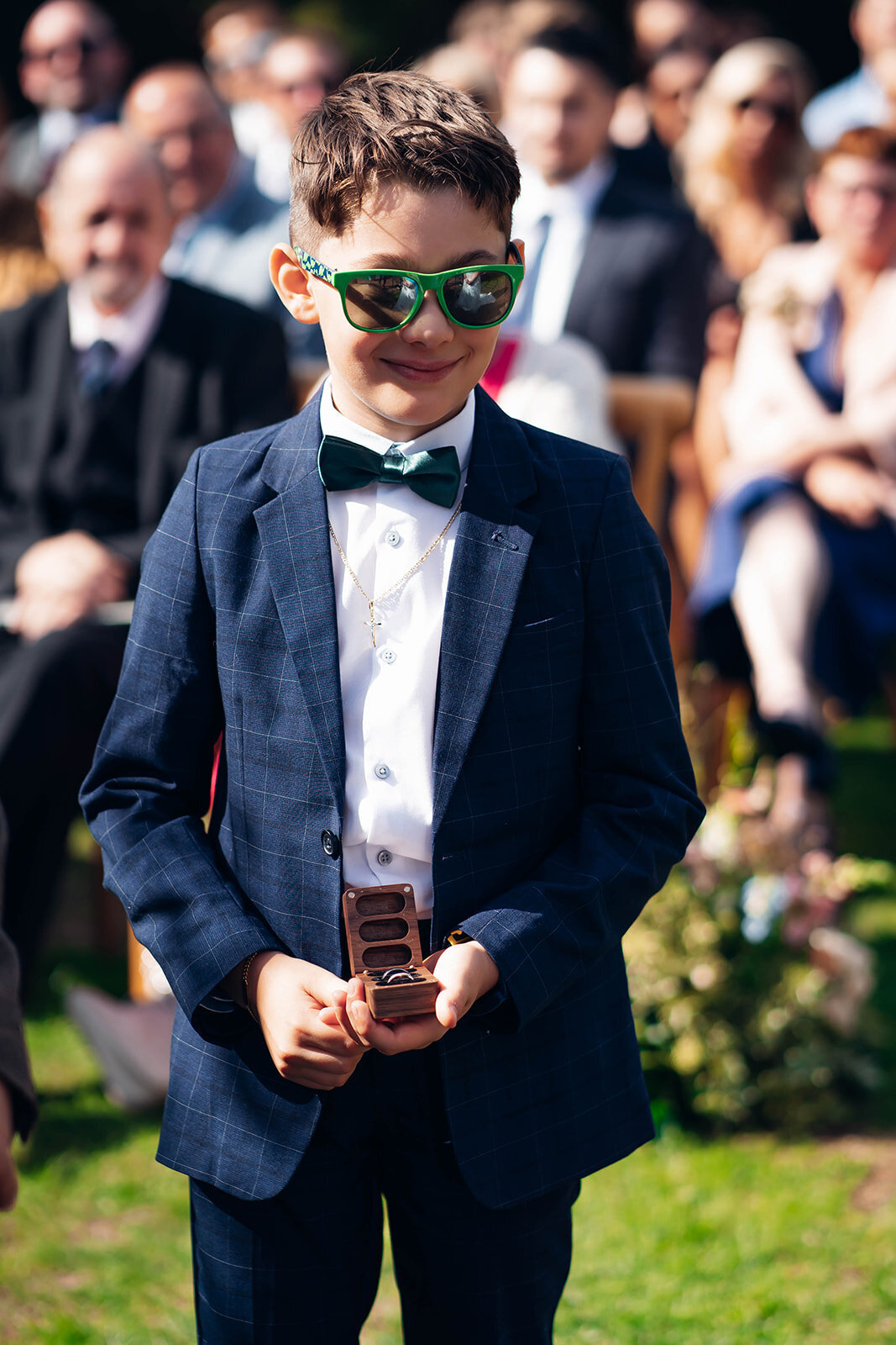 ring-bearer-deliverying-rings-during-outdoor-caswell-house-ceremony
