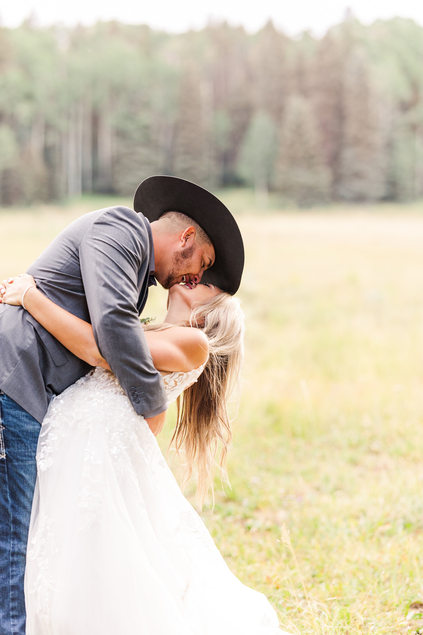 Groom dips his new bride for a kiss in this artistic image at their Arrow Head Lodge Wedding - 