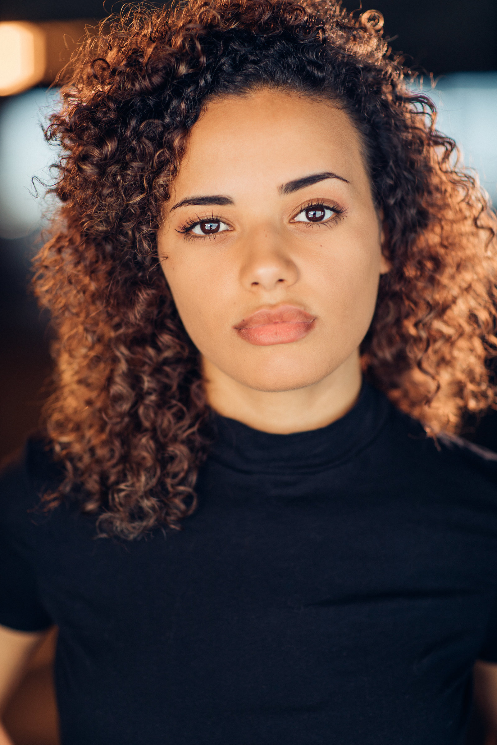 Headshot Photo Of Young Woman In Black Turtle Neck Shirt