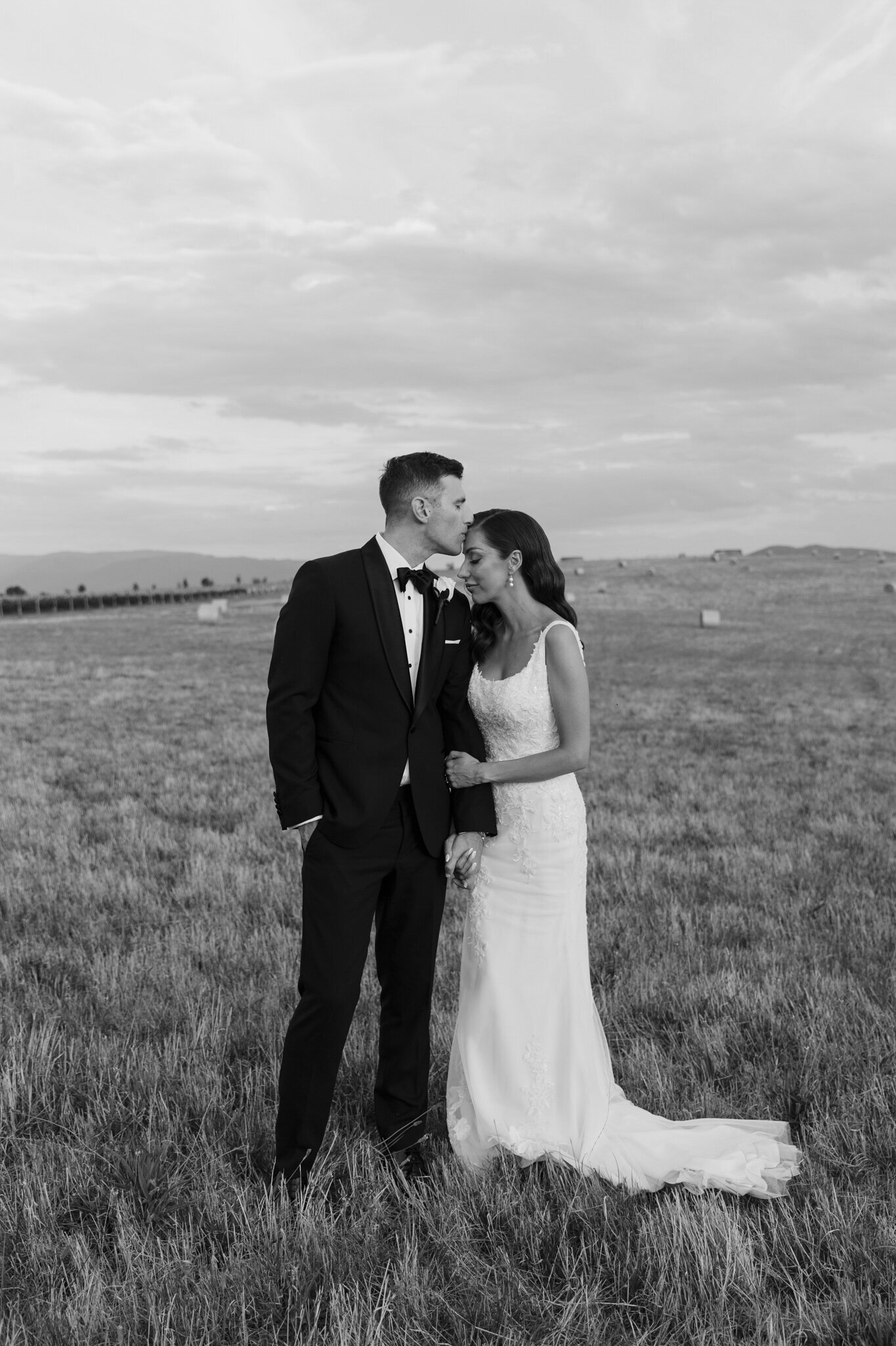 A bride and a groom in a field at Zonzo Estate Yarra Valley