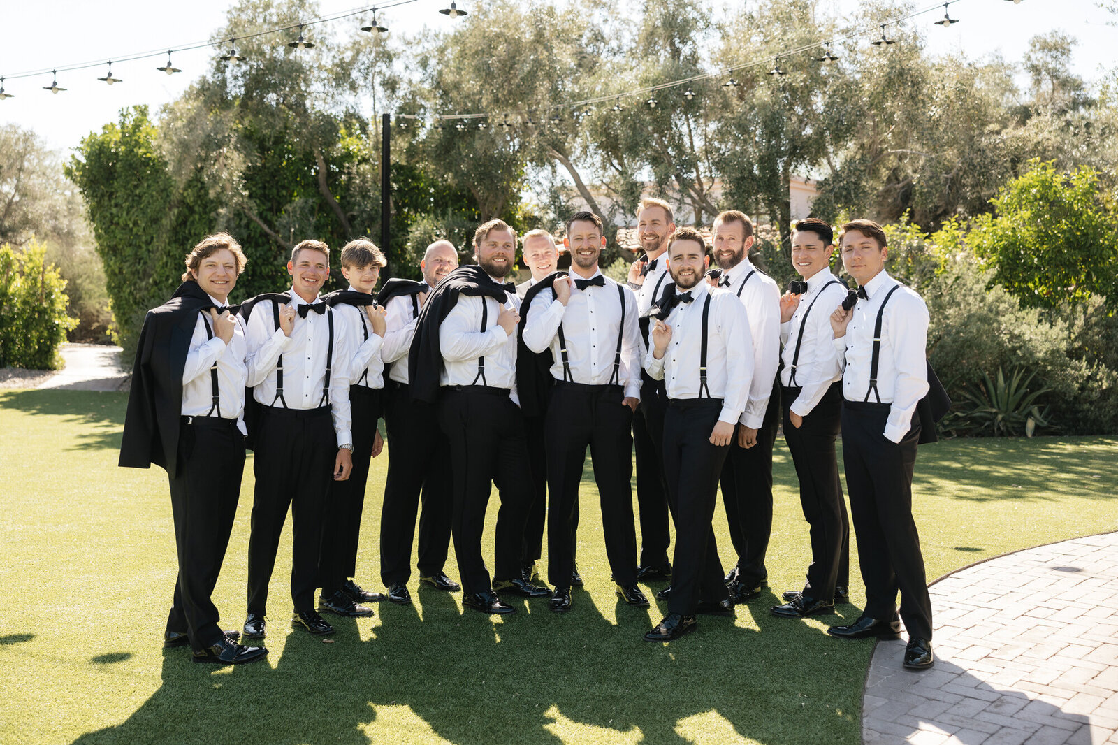 Groom and groomsmen posing for portrait at El Chorro in Paradise Valley taken by Arizona wedding videographer