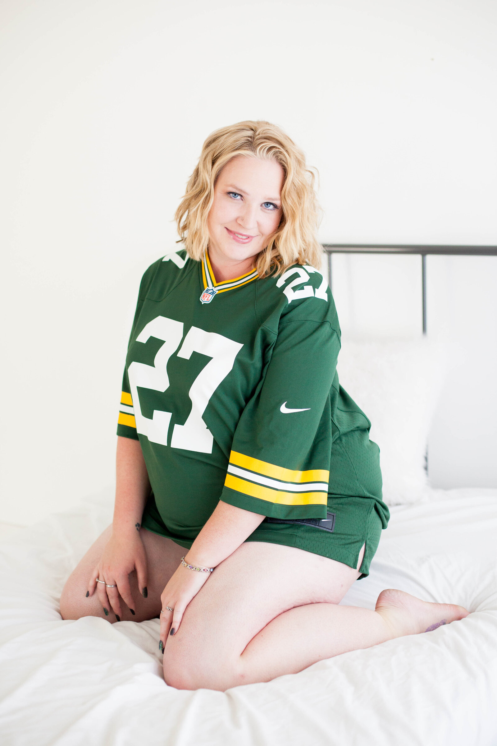 A blonde woman wearing a green and yellow jersey.