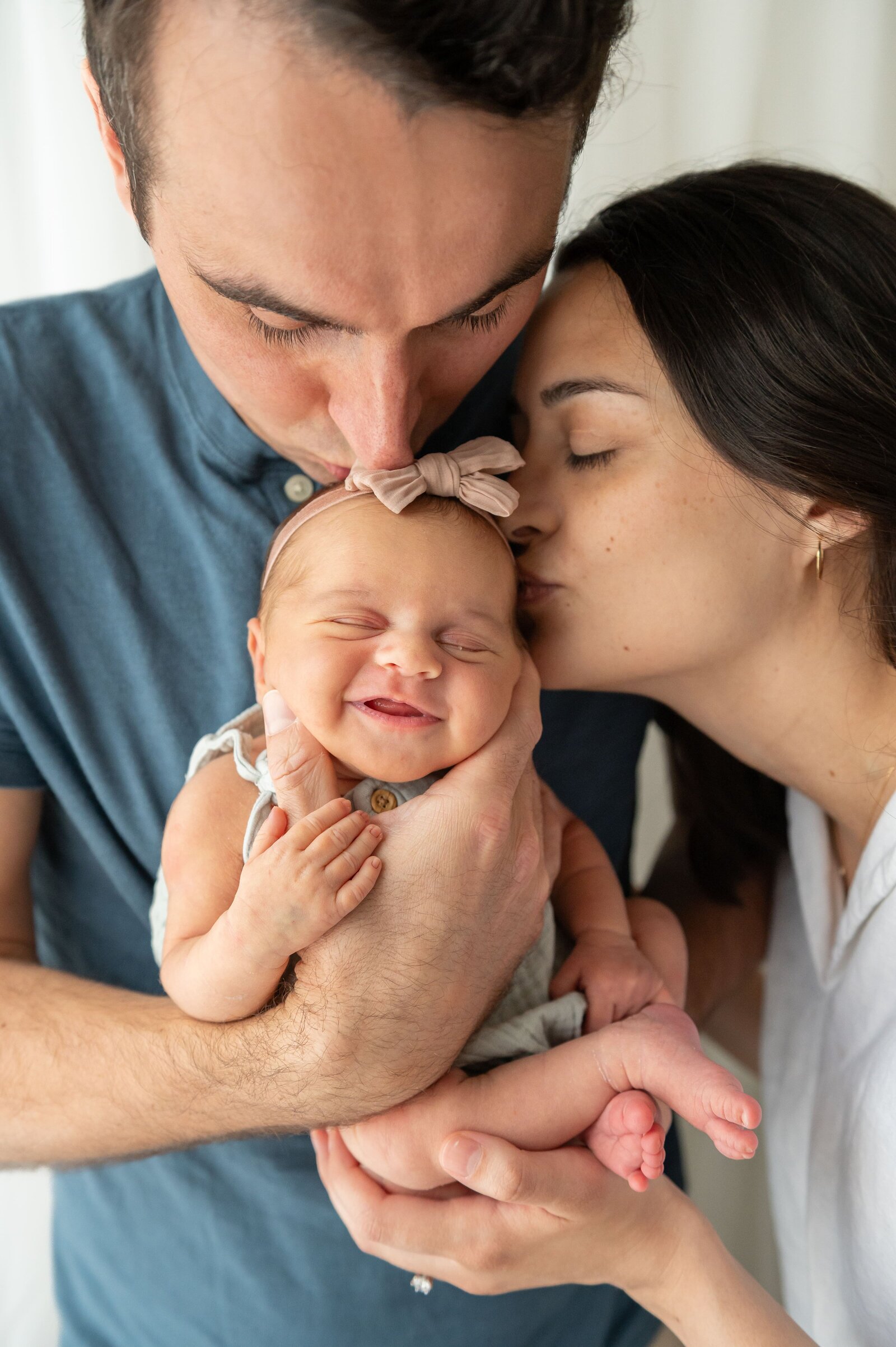 Mom and dad kissing sleeping baby