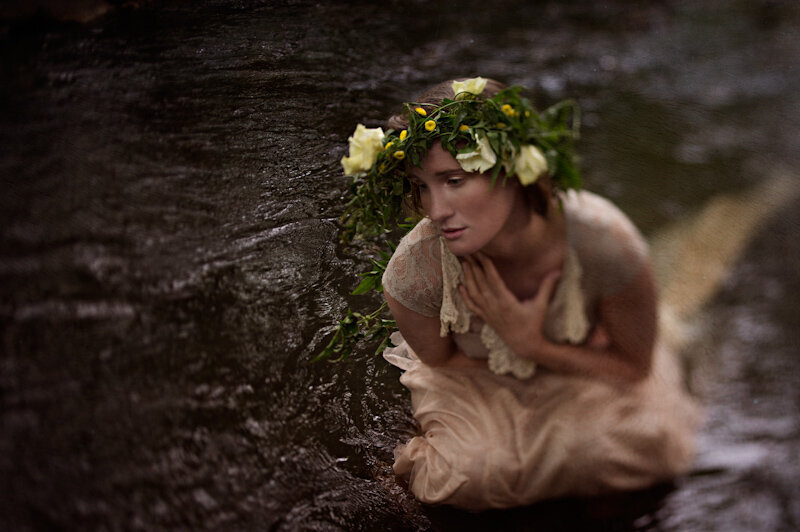 Makeup for a model sitting in a river with a flower crown