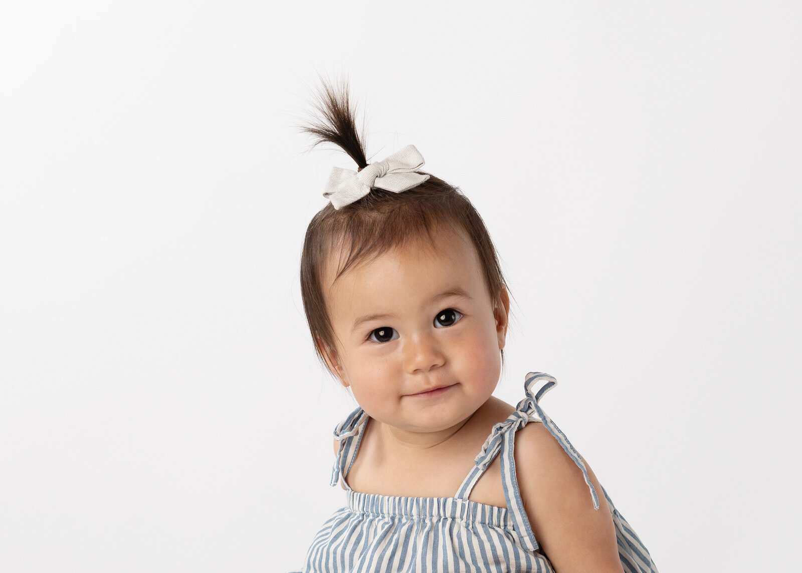 A little girl smiling for her school photo.