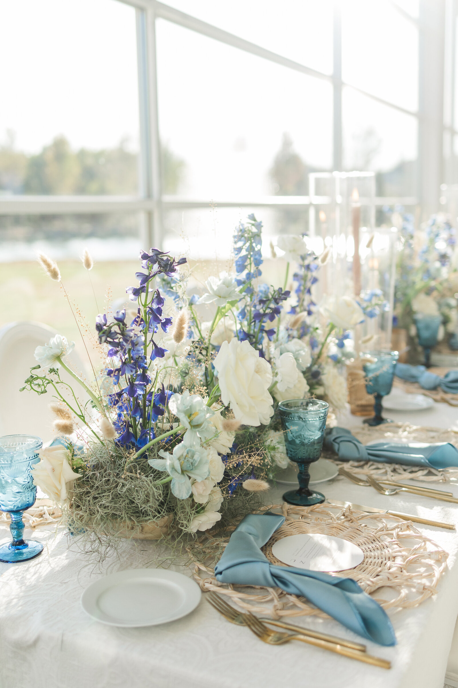 Luxurious floral arrangements decorate the head table, with a water fountain in the background.