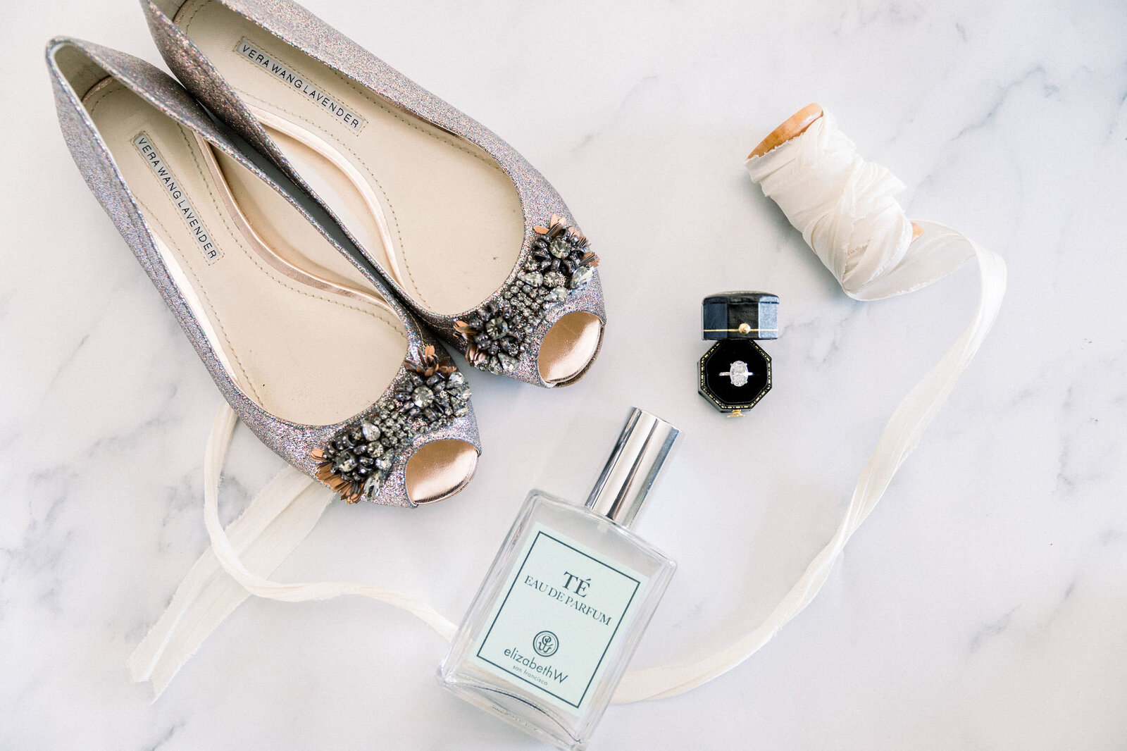 details of shoes, ring, and bridal perfume