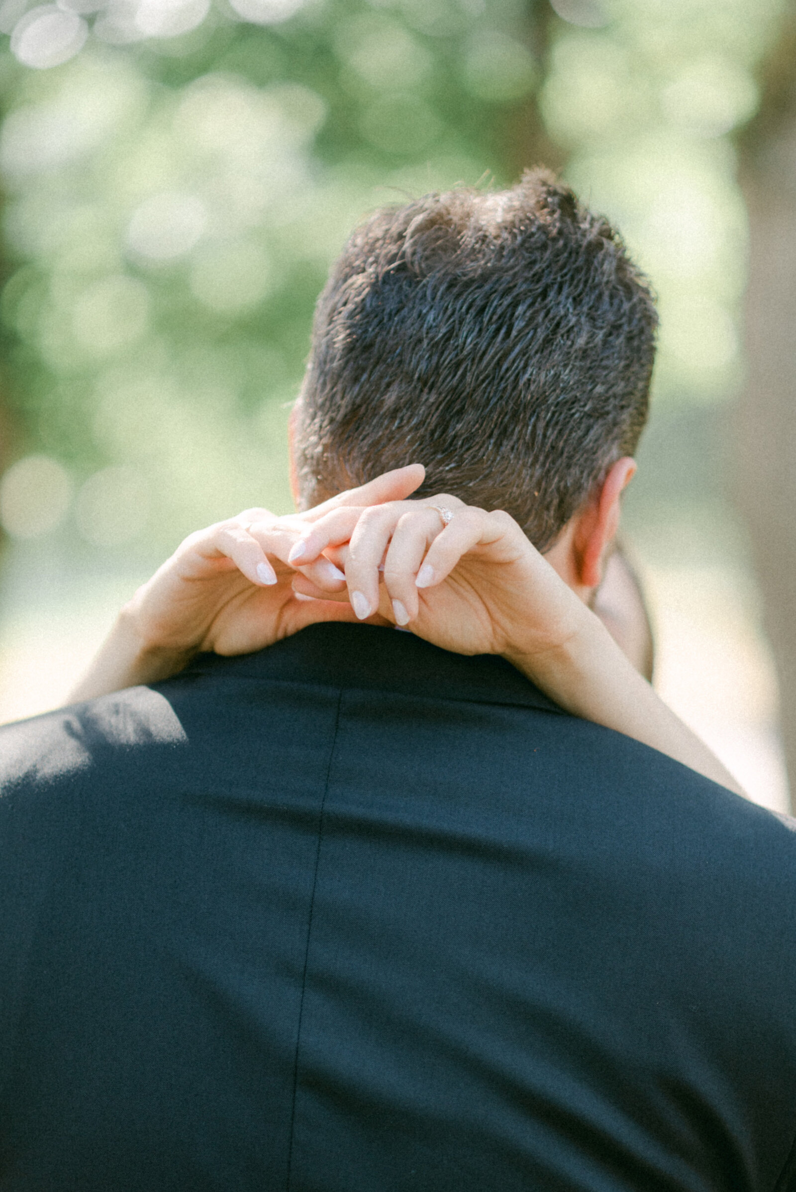 A close up image of the bride holding hands behind the groom's neck. A photograph captured by wedding photographer Hannika Gabrielsson.