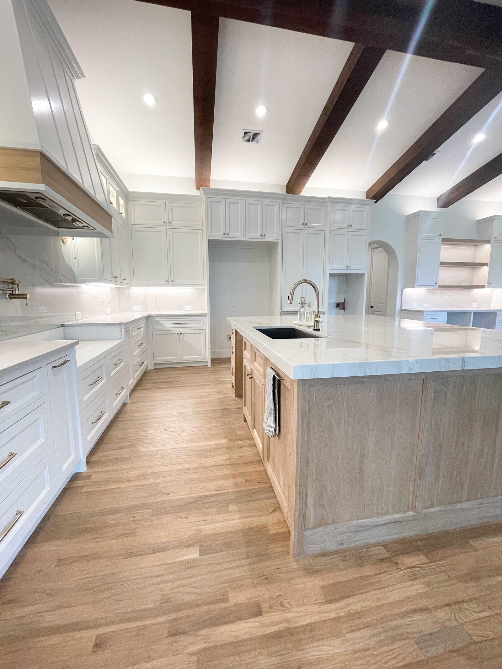 Home renovation and design featuring a white kitchen with unique furniture pieces, creating a modern and functional space that combines elegance with personalized style.