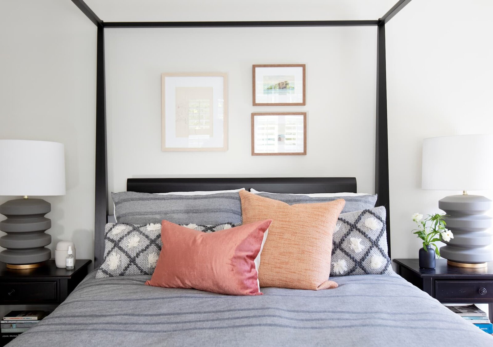 Granville Street l Canopy Bed with Peachy Tone Pillows and Mini Gallery Wall above Bed