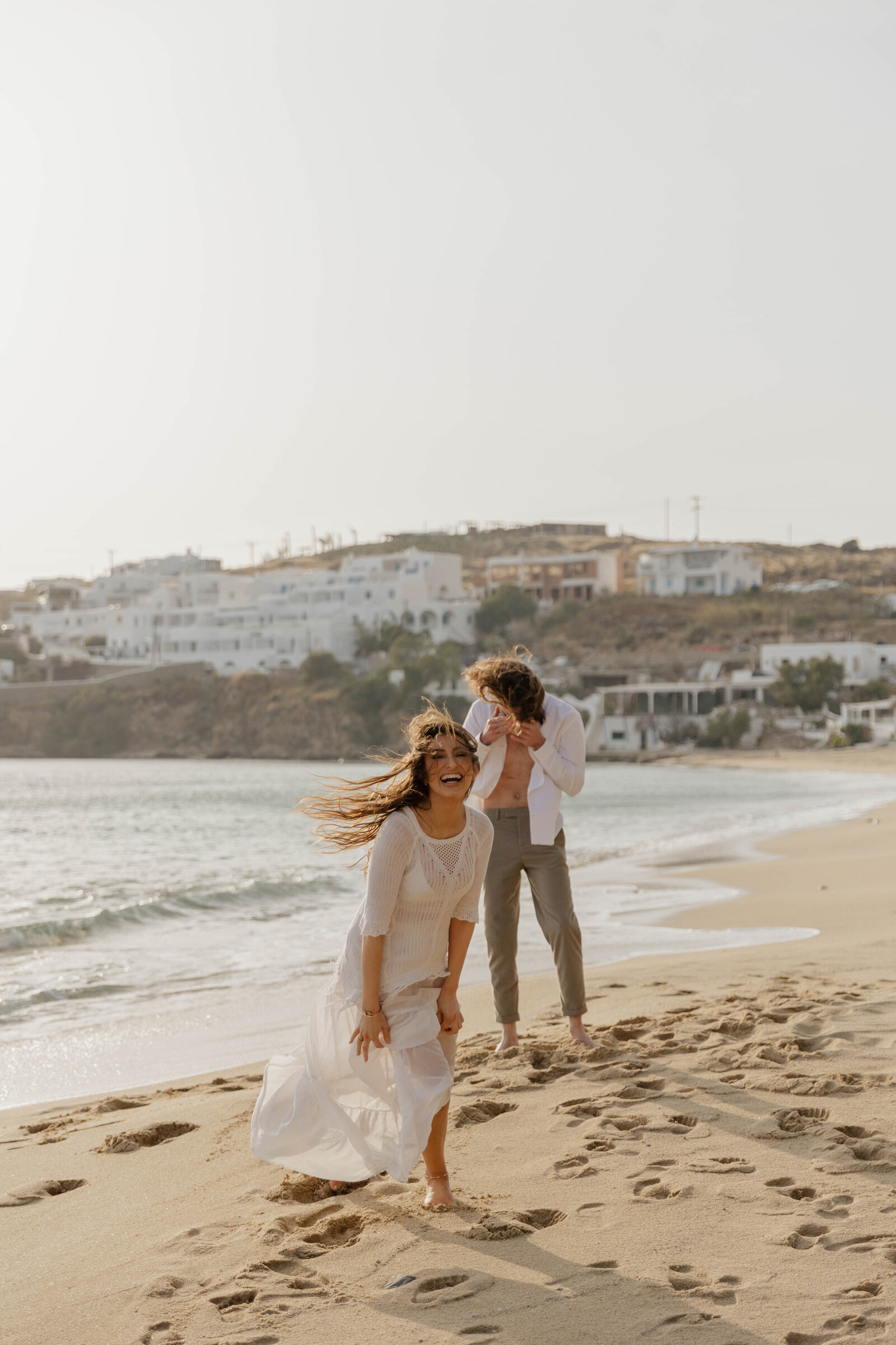 A couple on the beach with their elopement photographer.