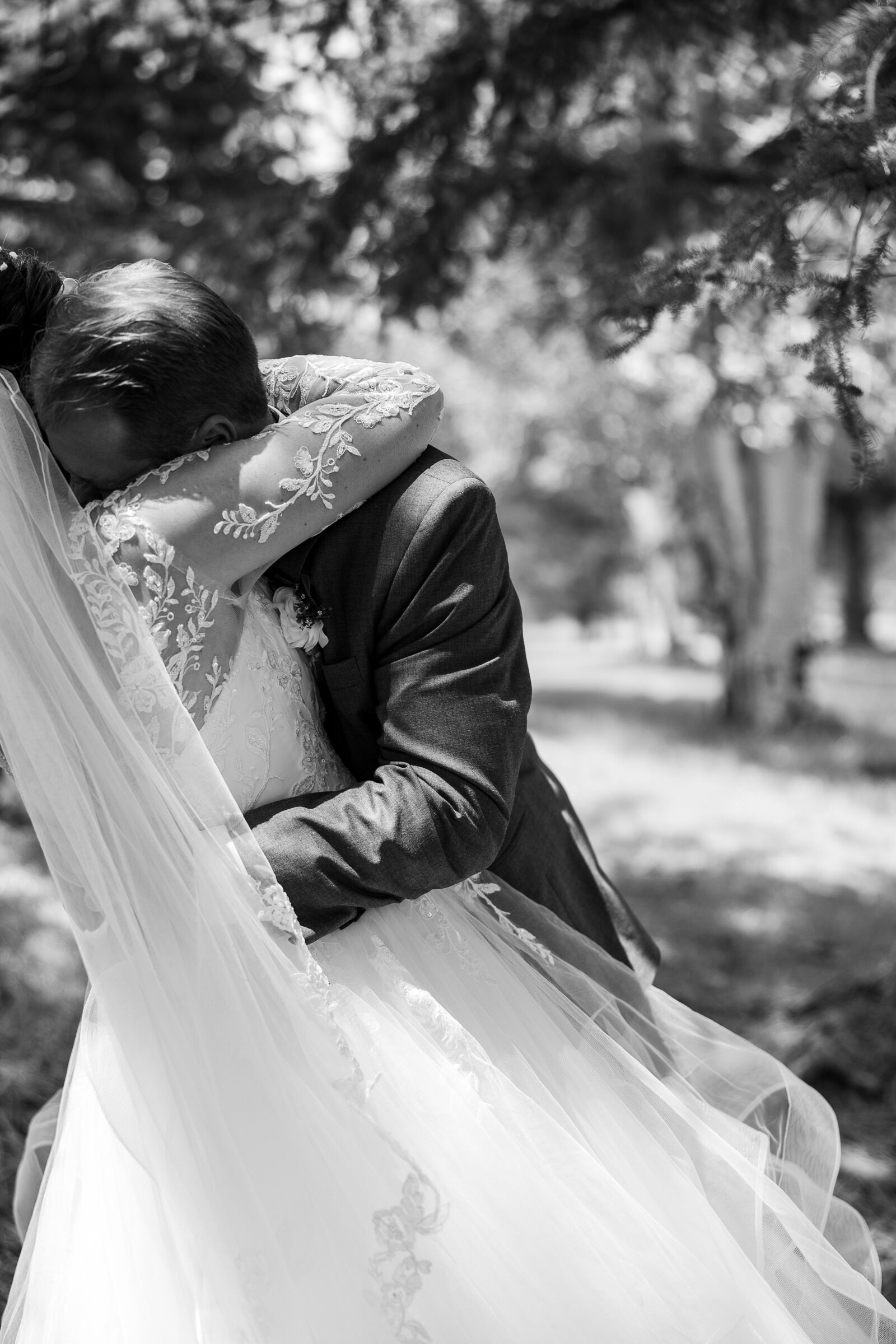 Black and white sweet moment captured when groom hugs bride after their first look