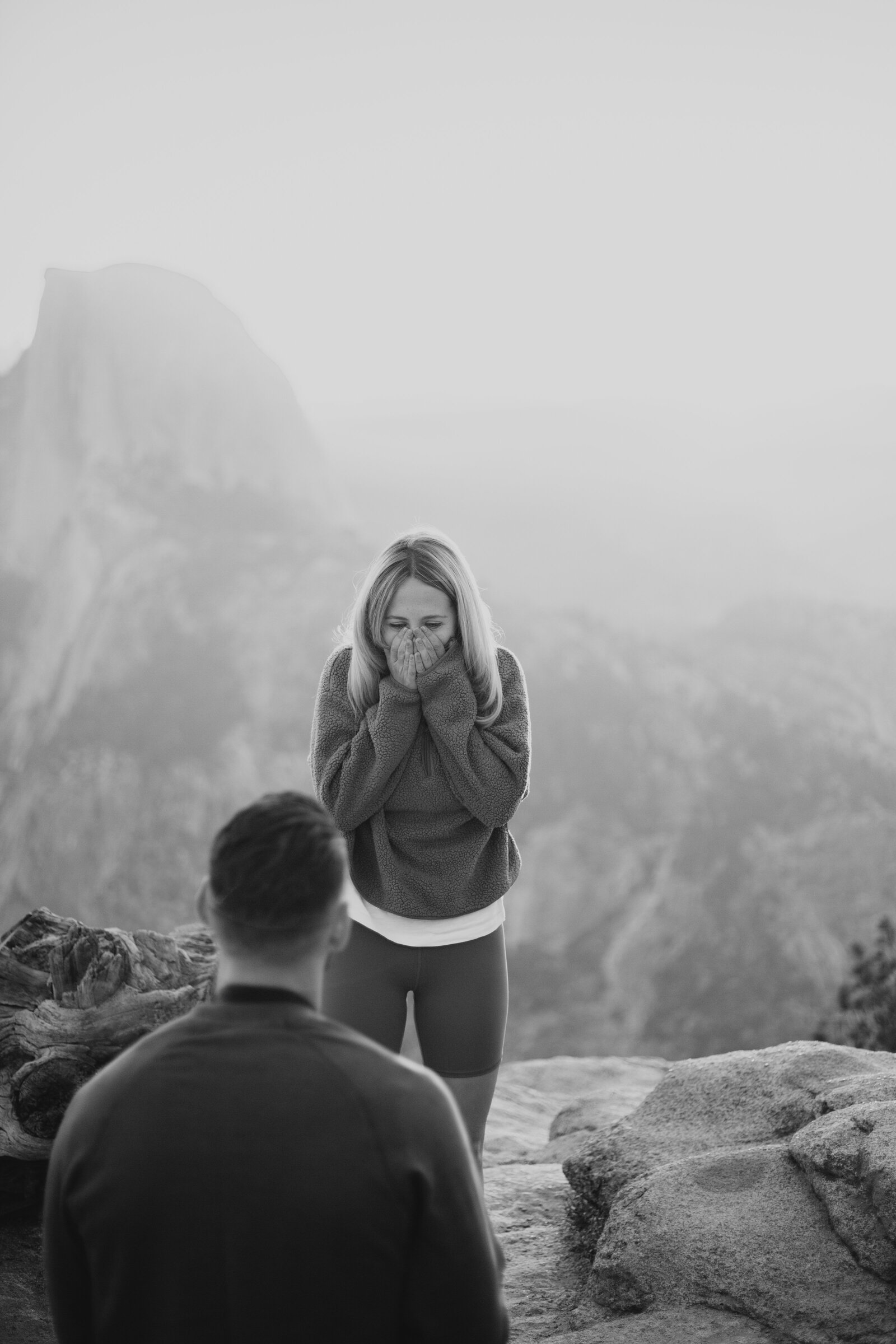 A wedding proposal between two hikers at sunrise in front of Half Dome in Yosemite National Park.
