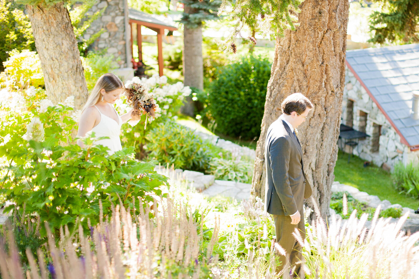 A woman holding her bouquet walking with her husband.