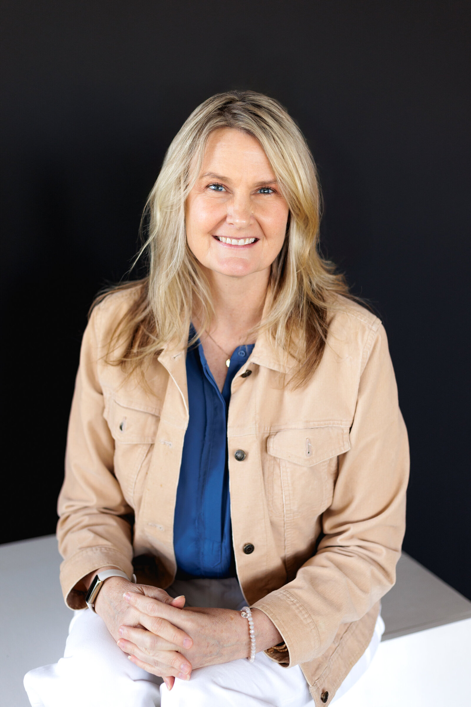 Headshot of woman against black background during content shoot in Portland, Oregon