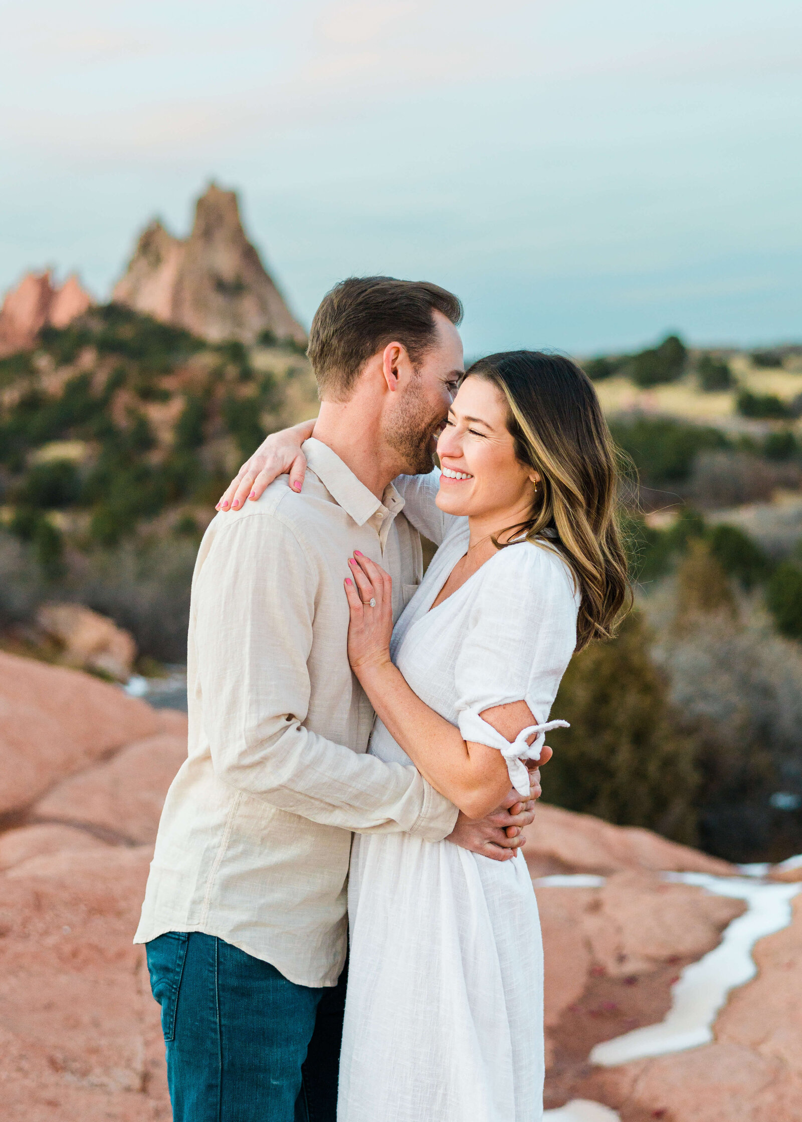 Man and woman snuggling during engagement session by Denver Wedding photographer