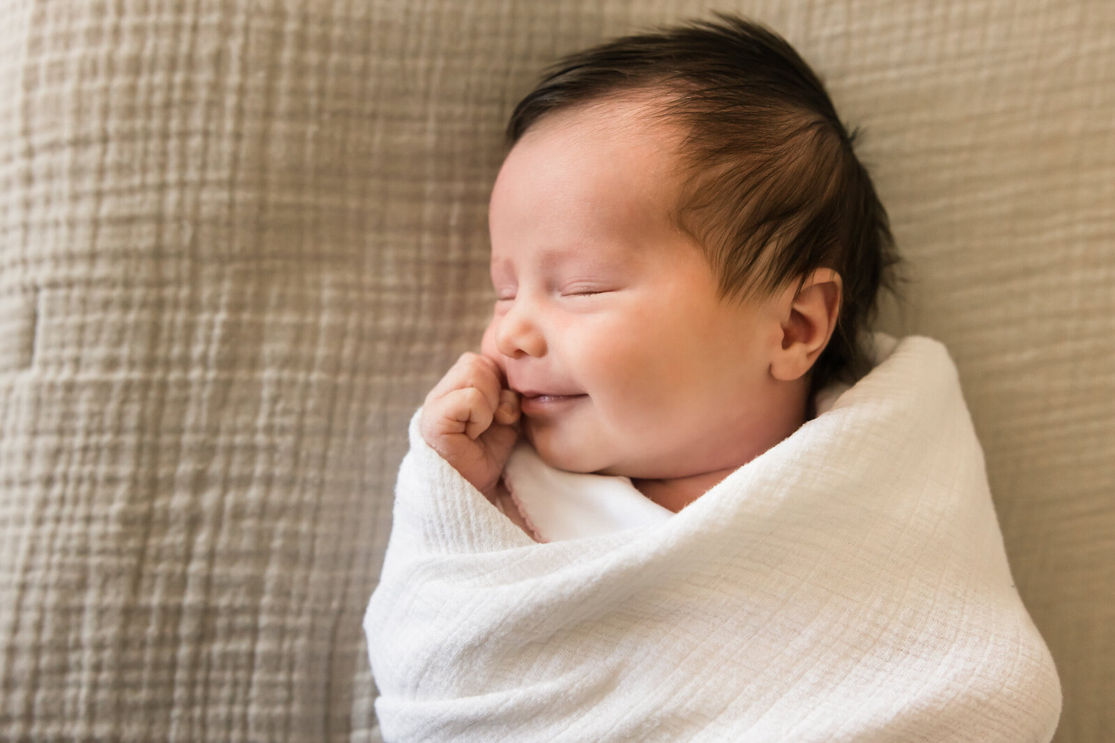 closeup of newborn baby girl smiling