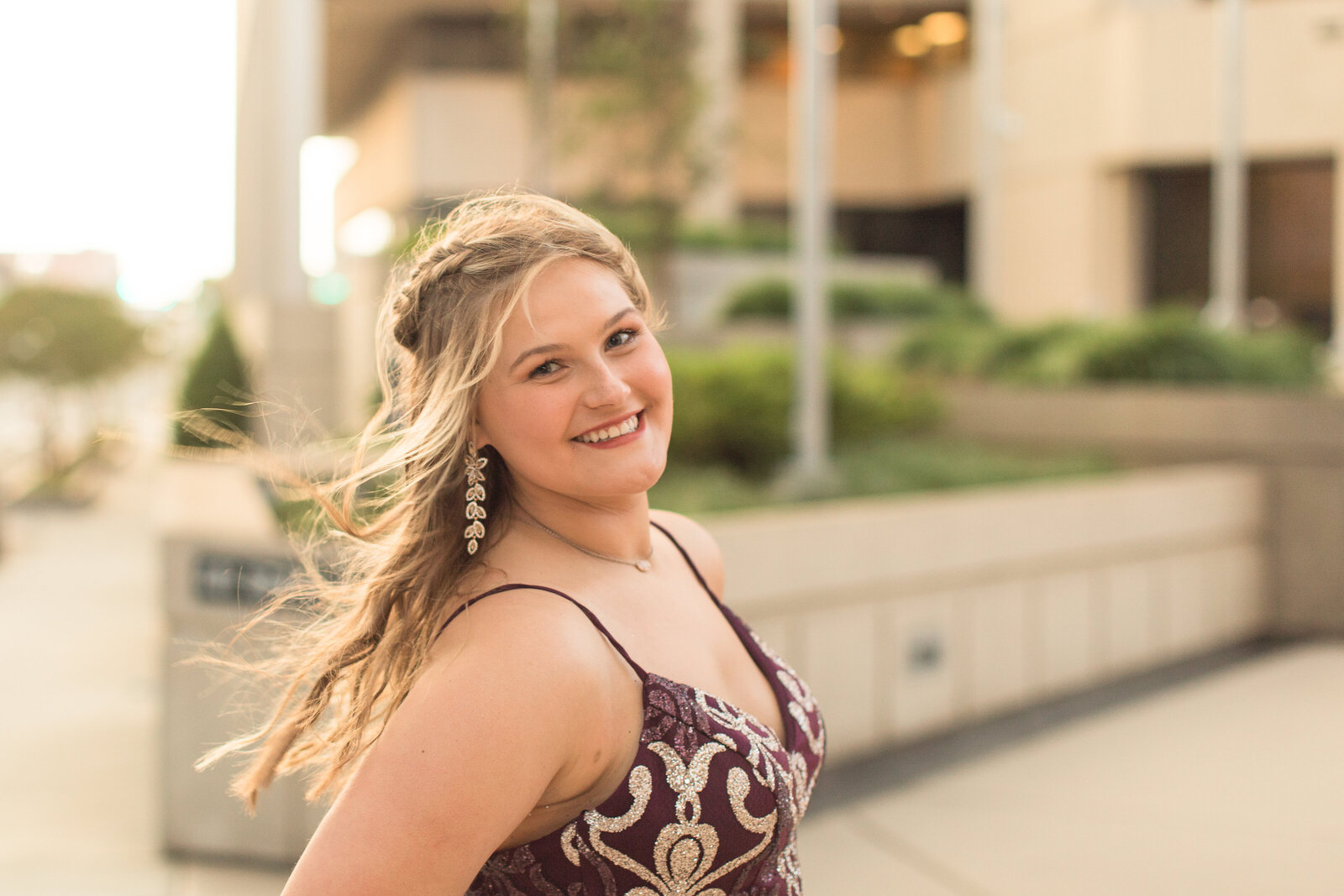 senior girl in prom dress downtown area