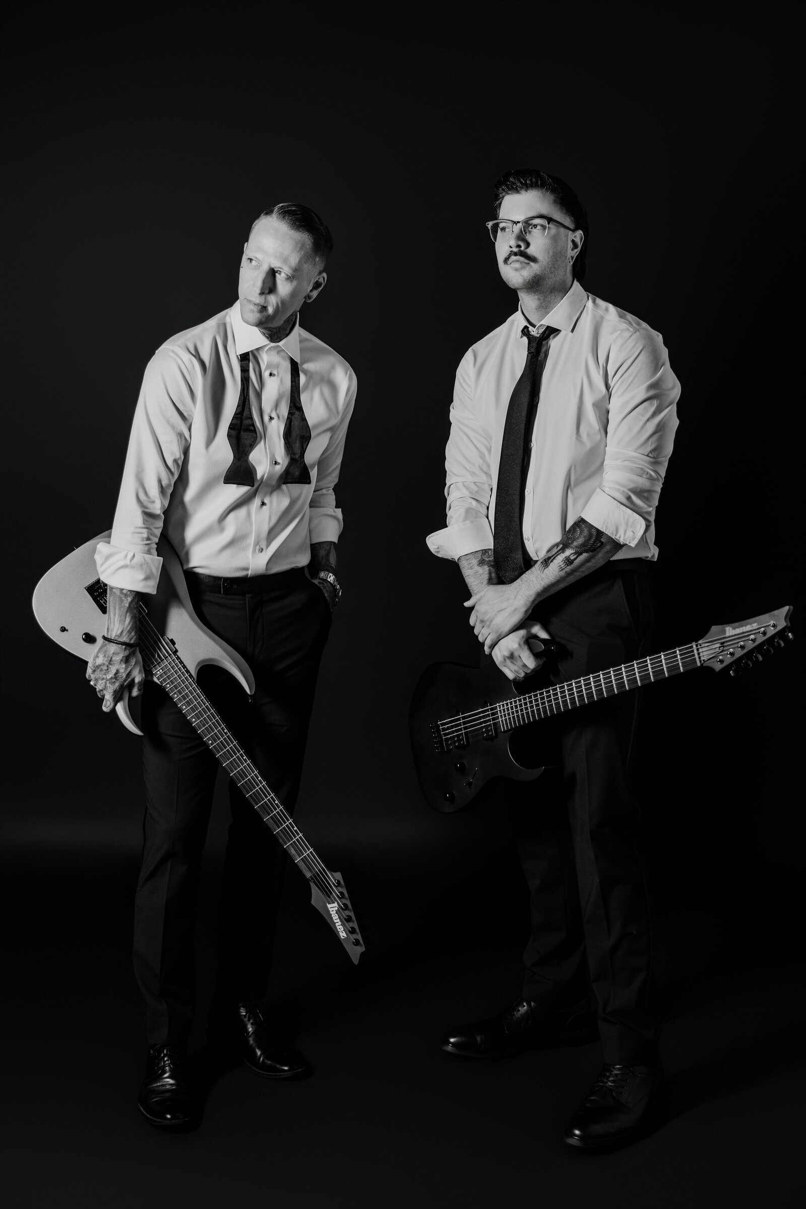 The Proper Collective creative team holding guitars— expert wedding videographers and photographers in the Midwest.