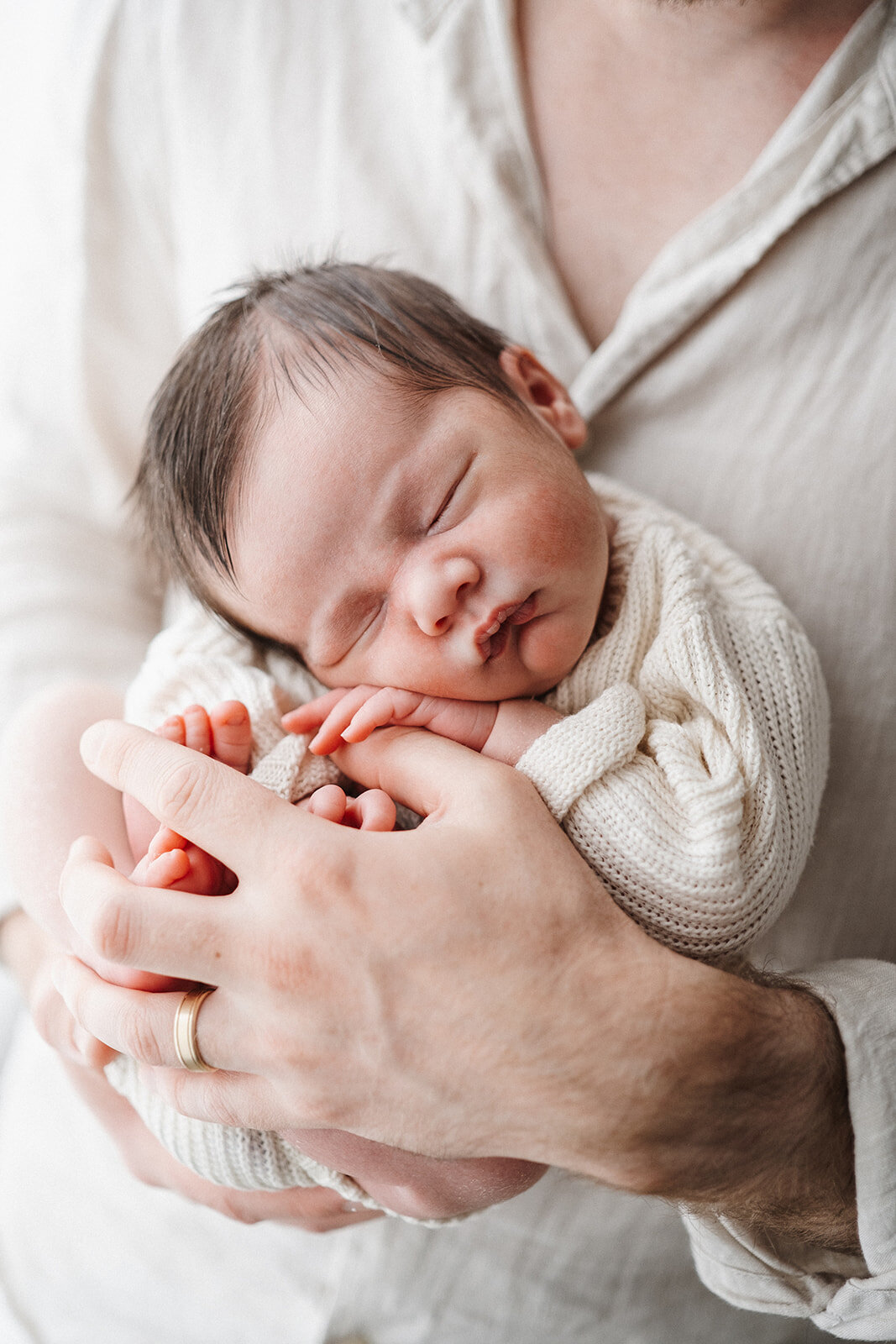 baby held in dads hands