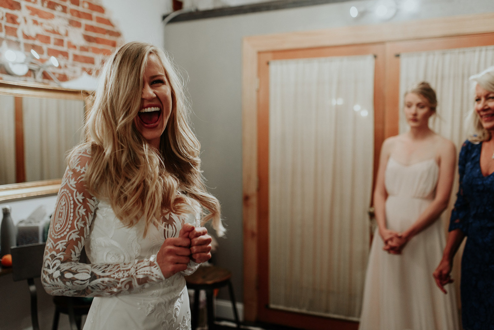 Cute picture of bride happily laughing at her wedding in Denver.