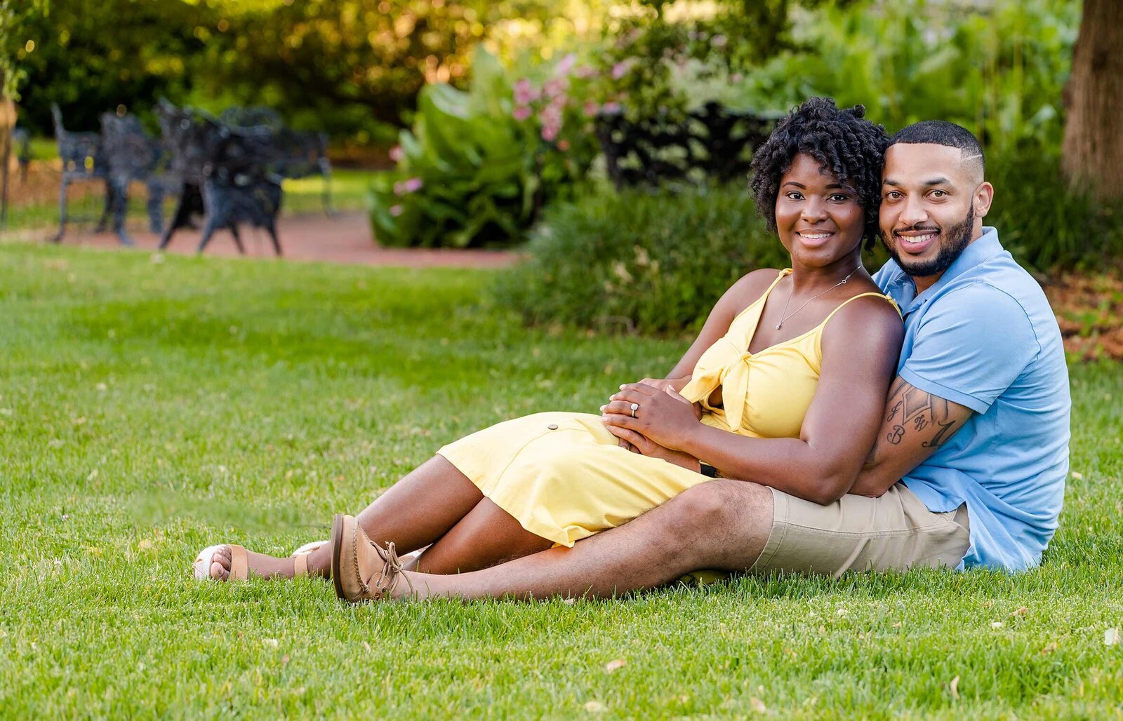 Couple poses for engagement family photos in Enid Haupt Gardens